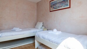 A room with two single beds, each with a pillow and a rolled towel. - **La Casa 67 – 2-Bedroom Apartment in Annecy City Center – Balcony** (Annecy)