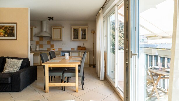 A compact living space with a dining area, kitchenette, and a balcony with outdoor seating. - **La Casa 67 – 2-Bedroom Apartment in Annecy City Center – Balcony** (Annecy)