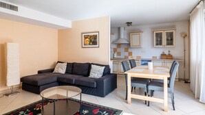 A living room with a sofa, a coffee table, and a dining area with a table and chairs. - **La Casa 67 – 2-Bedroom Apartment in Annecy City Center – Balcony** (Annecy)