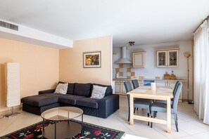 A living room with a sofa, a coffee table, and a dining area with a table and chairs. - **La Casa 67 – 2-Bedroom Apartment in Annecy City Center – Balcony** (Annecy)