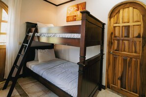 A bunk bed with a ladder, a wooden door, and a painting on the wall. - Peaceful 2-bedroom Villa with AC in beautiful Tamarindo
Steps from the Pool (Tamarindo)