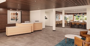 Un hall d’hôtel moderne avec un comptoir d’accueil, un espace salon et de grandes fenêtres.