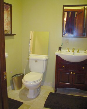 A bathroom with a toilet, sink, and mirror. - Executive suite located between2 great golf courses in West Los Angeles (Los Angeles)
