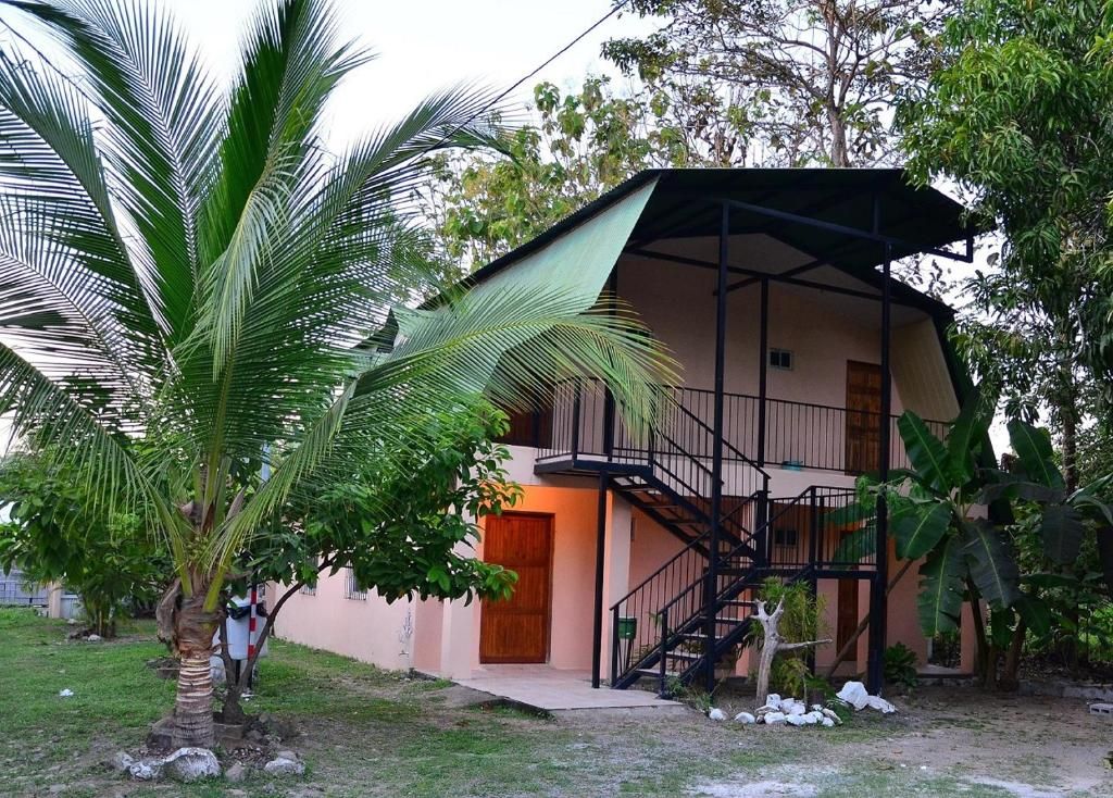A two-story building with a balcony and a staircase.