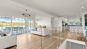 A modern interior with a dining area, a sofa, and a kitchen.