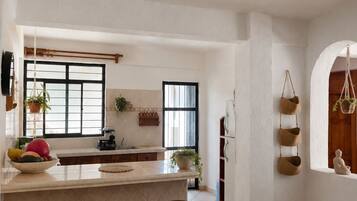 Full-sized fridge, oven, stovetop, cookware/dishes/utensils