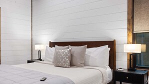 A bedroom with a bed, two bedside tables, and a nightstand. - 5BR Hochatown Cabin: Hot Tub - Game Room - Fits 13 - Min to Lake & Casino (Broken Bow)
