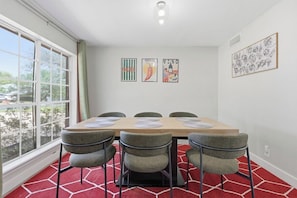 A dining area with a table, chairs, and artwork on the walls. - Coronado Hills Retreat - Pool + Game Room Fun (Austin)
