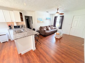A compact living space with a kitchenette, a sofa, and a dining area. - Relaxing Coastal Home (Jacksonville)