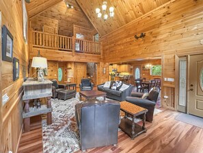 A spacious log cabin interior with a living area, dining space, and a kitchen. - Copper Top - Mountain Views | Hot Tub | Expansive Patio (Blue Ridge)