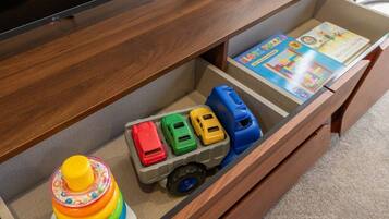 A wooden cabinet with a toy truck and a children's toy.