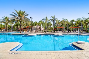 A swimming pool with multiple lanes, palm trees, and lounge chairs. - Lanai Luxury - Solterra - Modern Retreat With Private Pool, Lanai, Central AC & gas Grill (Davenport)