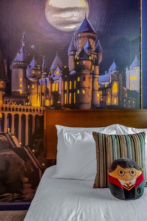 A bedroom with a large bed, a pillow, and a wall mural of a castle. - Modern Home at Sonoma! Sleeps 32 A Kissimmee Vacation Rental (Kissimmee)