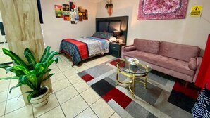 A room with a bed, a sofa, a coffee table, and a potted plant. - Estudiocentrico Loft, Tijuana, BC (Tijuana)