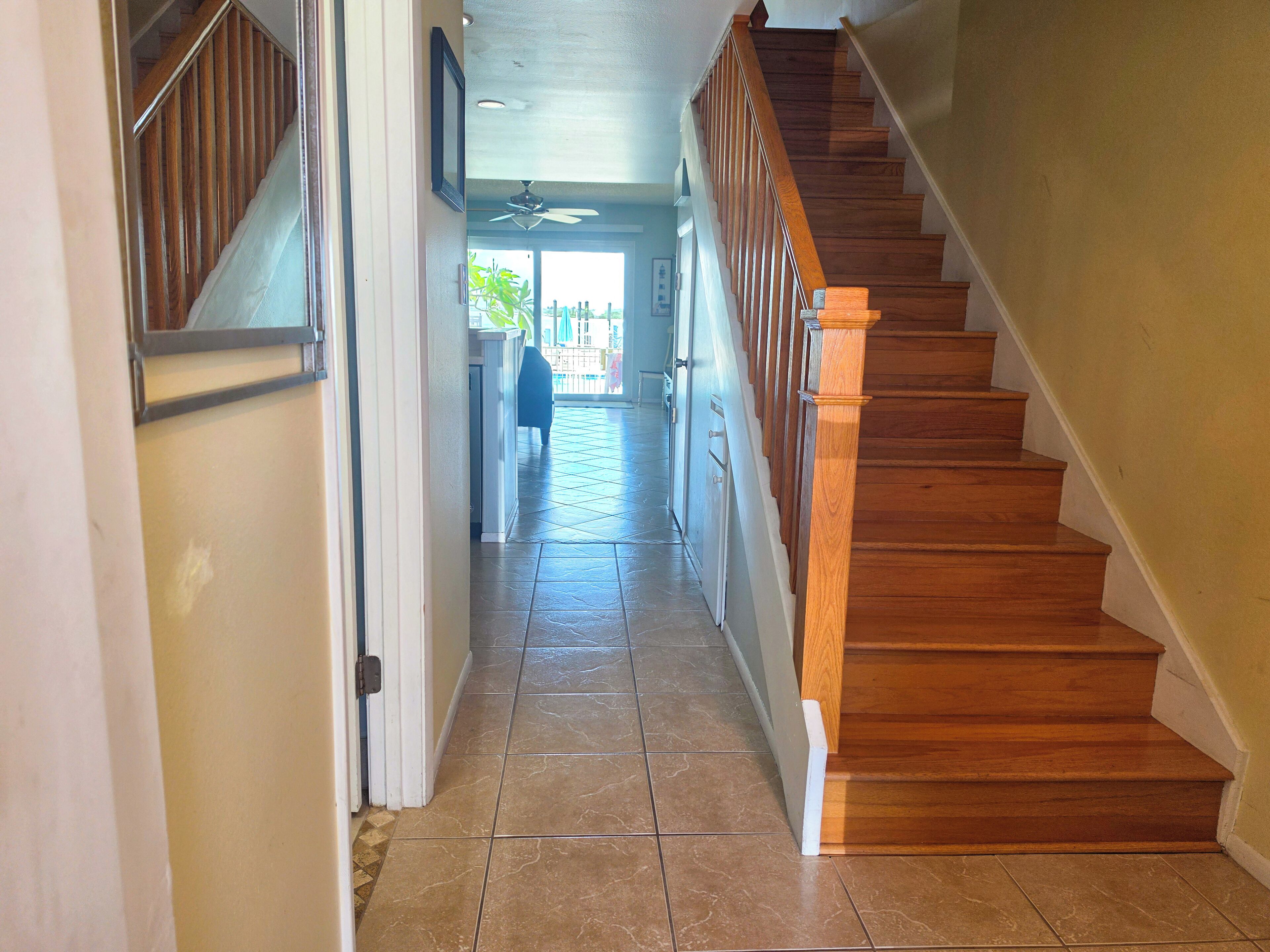 A staircase with wooden steps and a handrail, leading to an upper floor.
