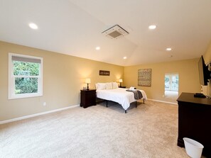 A bedroom with a bed, bedside tables, a dresser, a window, and a wall with motivational quotes. - Spacious McMinnville Retreat | 5 Bedrooms | Pet Friendly (Mcminnville)