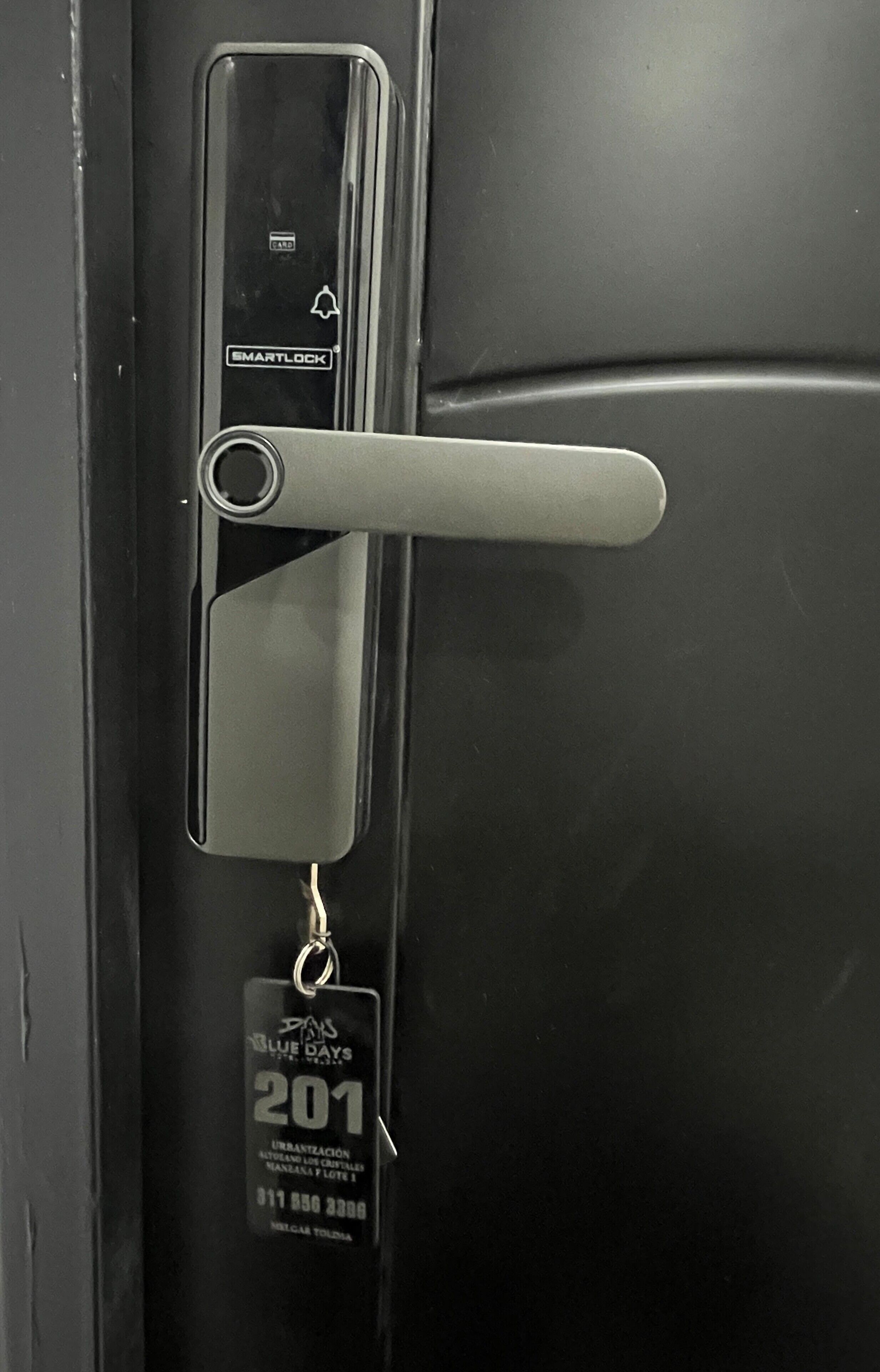 A door with a keyhole, a card slot, and a keychain with a tag.