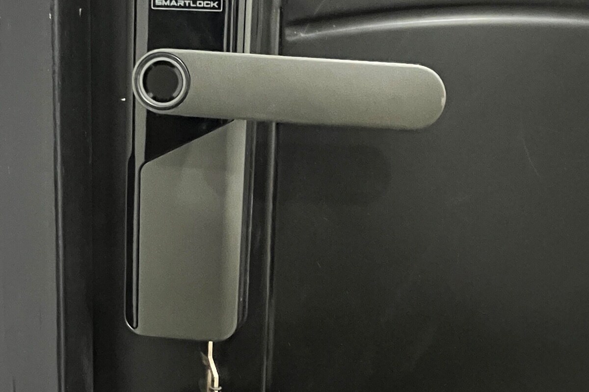 A door with a keyhole, a card slot, and a keychain with a tag.