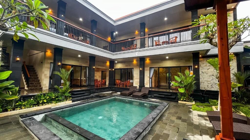 A multi-level outdoor pool area with seating and a staircase.