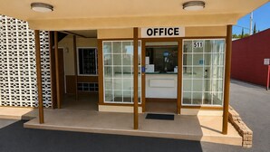 A building entrance with a sign reading 'OFFICE' and a number '511' above the door.