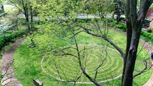 A circular garden with a winding path and a bench. - Incredible Location Converted Suite in Music Row! (Nashville)