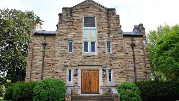 A stone building with a central wooden door, two windows on each side, and a small staircase leading up to the entrance. - AWESOME Location!! Budget Friendly Historic Suite! (Nashville)