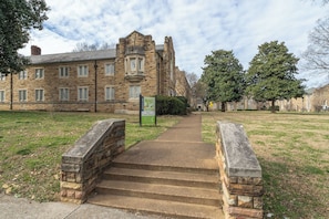 A stone building with a central staircase leading to a gated entrance. - Cozy Suite in a Historic Building! GREAT location (Nashville)