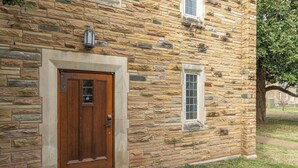 A stone building with a wooden door and a small window. - Private Suite in a Great Location - Music Row! (Nashville)