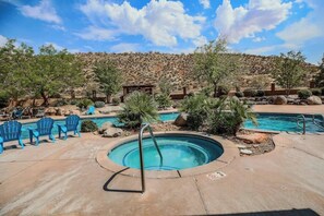 A pool area with a hot tub, lounge chairs, and a desert landscape in the background. - Splash Zone | A Family Favorite near Zion (Hurricane)