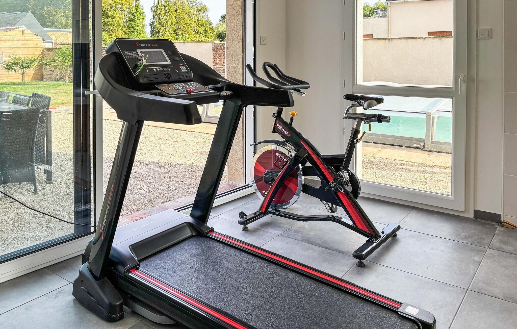A home gym with a treadmill and an exercise bike.