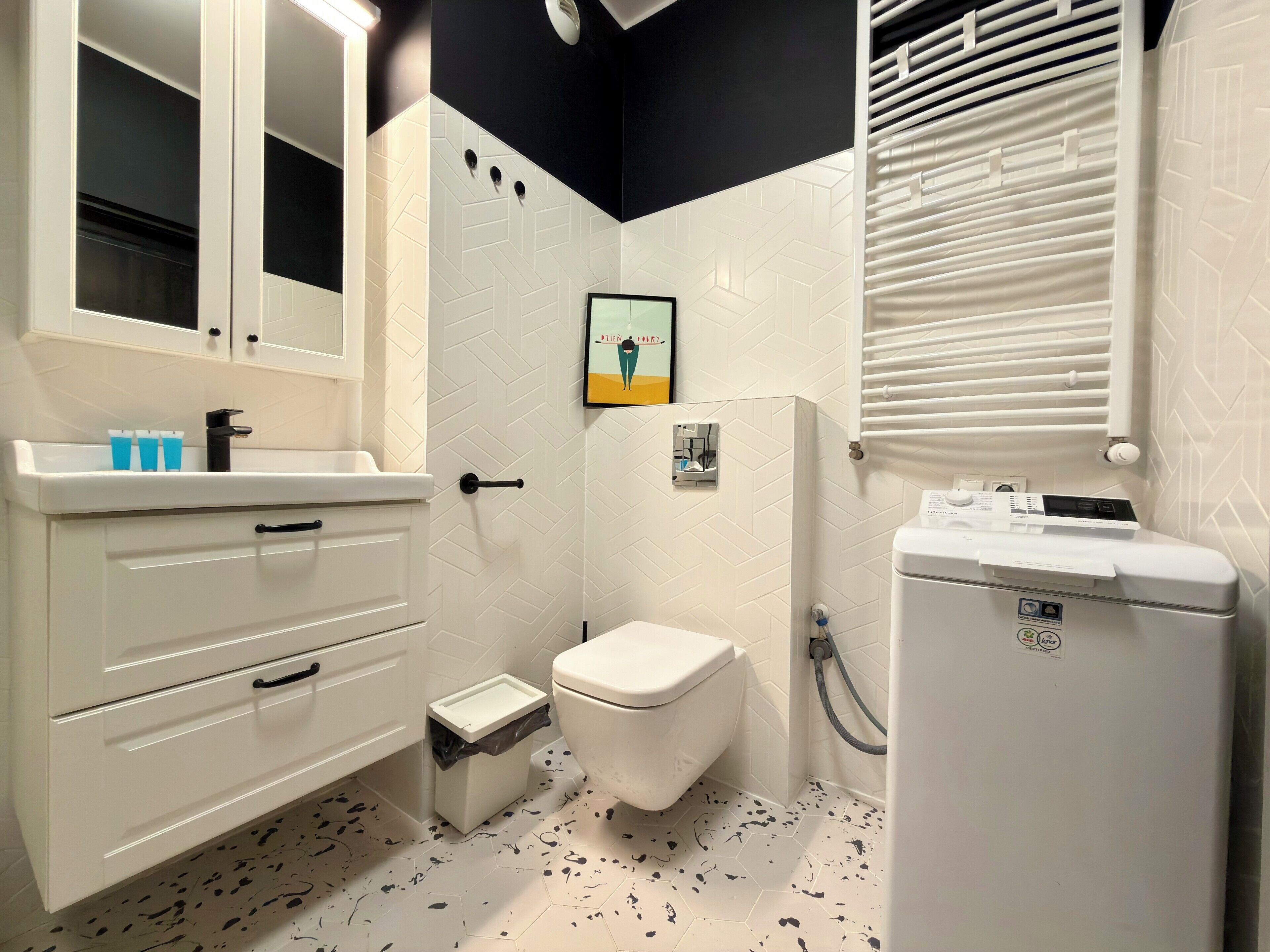 A bathroom with a toilet, sink, and shower area.