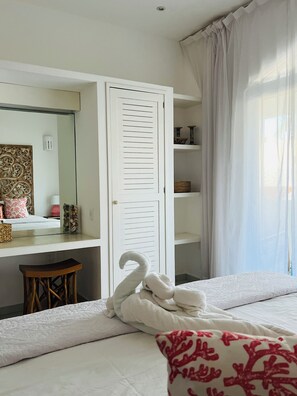 A bedroom with a bed, a white wardrobe, a mirror, and a window with curtains. - OTOMI HOUSE, PUERTO MORELOS (Puerto Morelos)