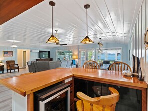 A spacious kitchen with a wooden island, pendant lights, and a view to the outside. - Welcome to the Boat House (Kelseyville)