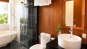A modern bathroom with a glass-enclosed shower, a toilet, and two sinks. - Delux Room resort in fabulous Kedewatan Ubud (Kedewatan ubud)