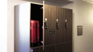 A wardrobe with a sliding door, a luggage rack, and a wheelchair accessibility sign.