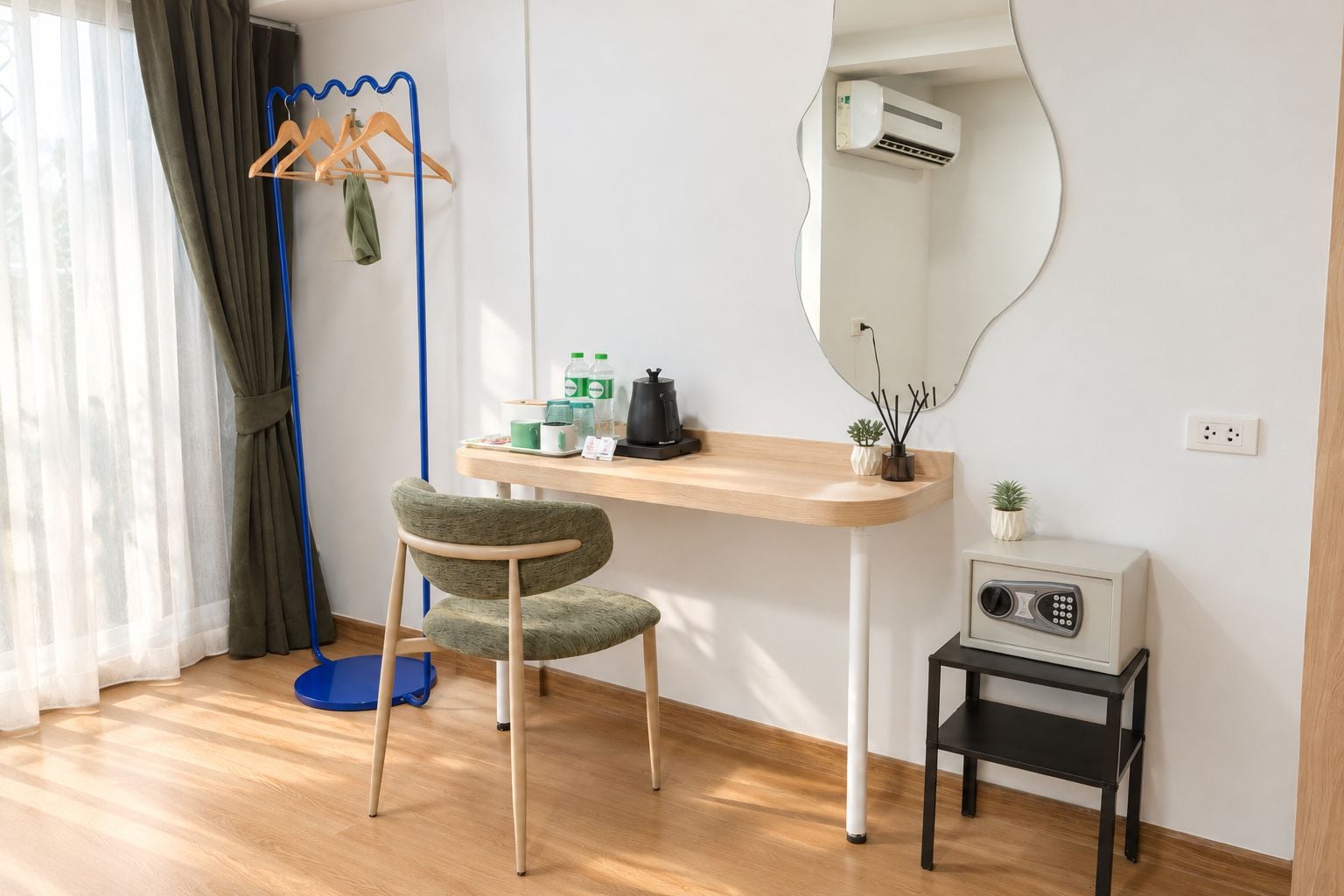 Une pièce comprenant un bureau en bois, une chaise, un miroir, un climatiseur, une radio et une lampe de sol.