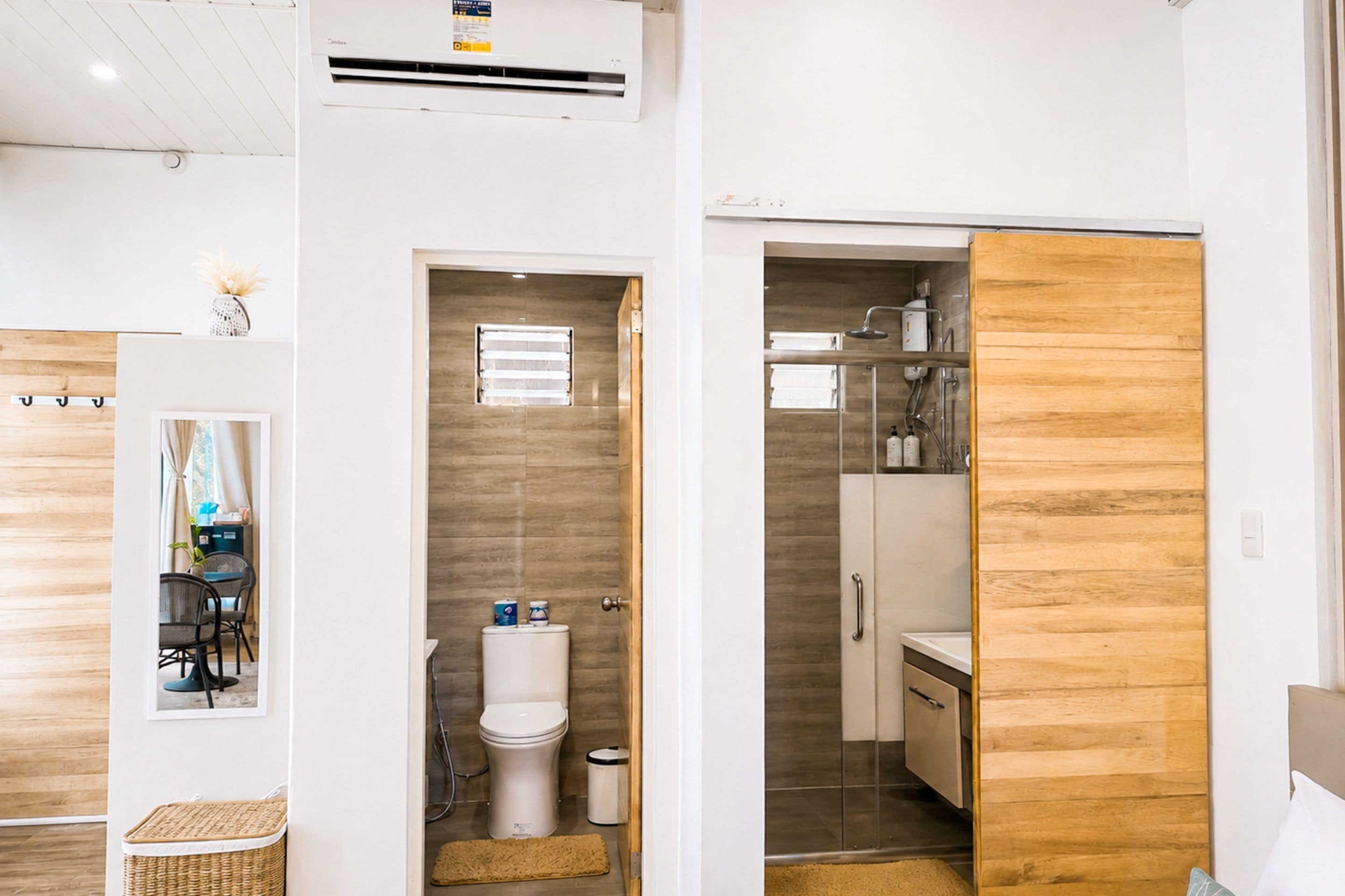 A compact bathroom with a toilet, bidet, and a small sink.