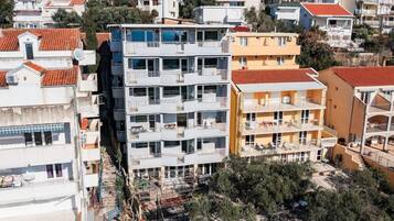 A multi-story residential building with balconies, a central courtyard, and a mix of architectural styles.