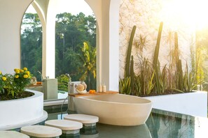 A modern bathroom with a freestanding bathtub, a shower, and a large window with a view of greenery. - 2 Infinity Pools • Luxury Ubud 1br Villa • Jungle Paradise (Ubud)
