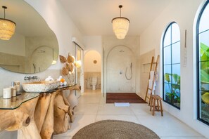 A modern bathroom with a large mirror, wooden vanity, and a shower area. - 2 Infinity Pools • Luxury Ubud 1br Villa • Jungle Paradise (Ubud)