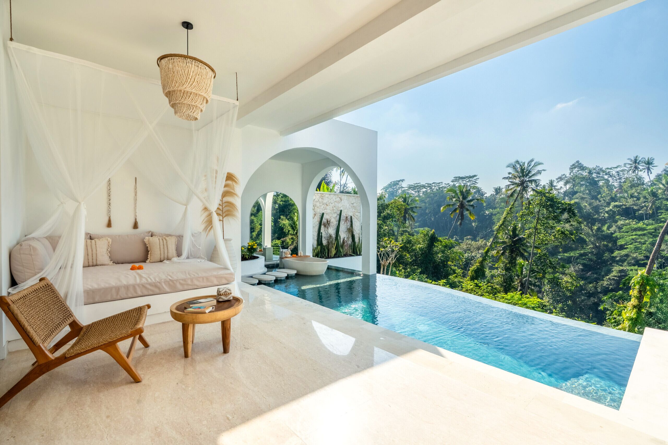 A modern infinity pool with a clear view of a lush tropical landscape.