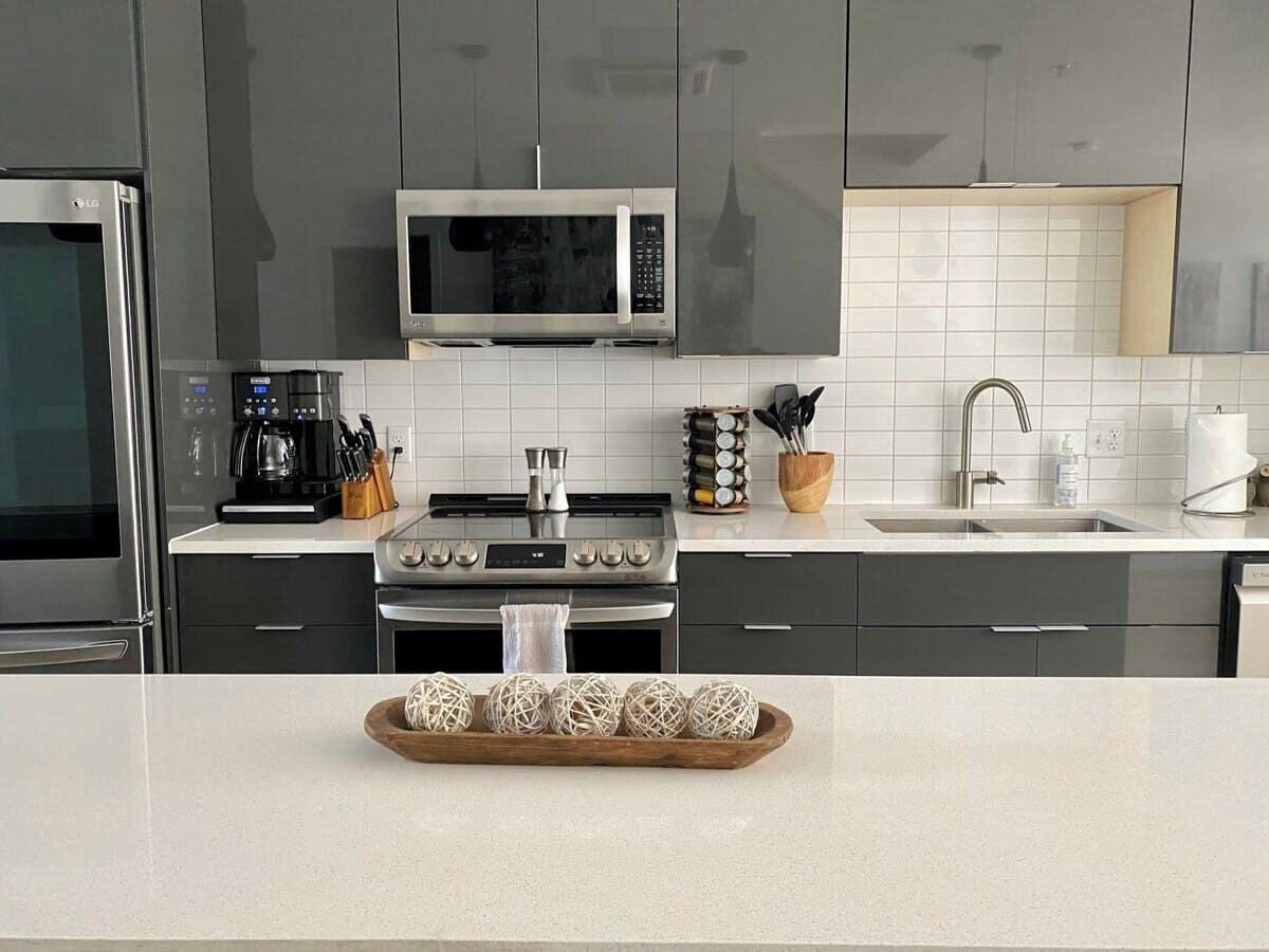 A modern kitchen with stainless steel appliances, a microwave, and a stove.
