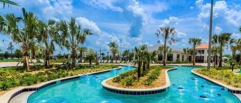 A pool area with multiple water slides and palm trees.