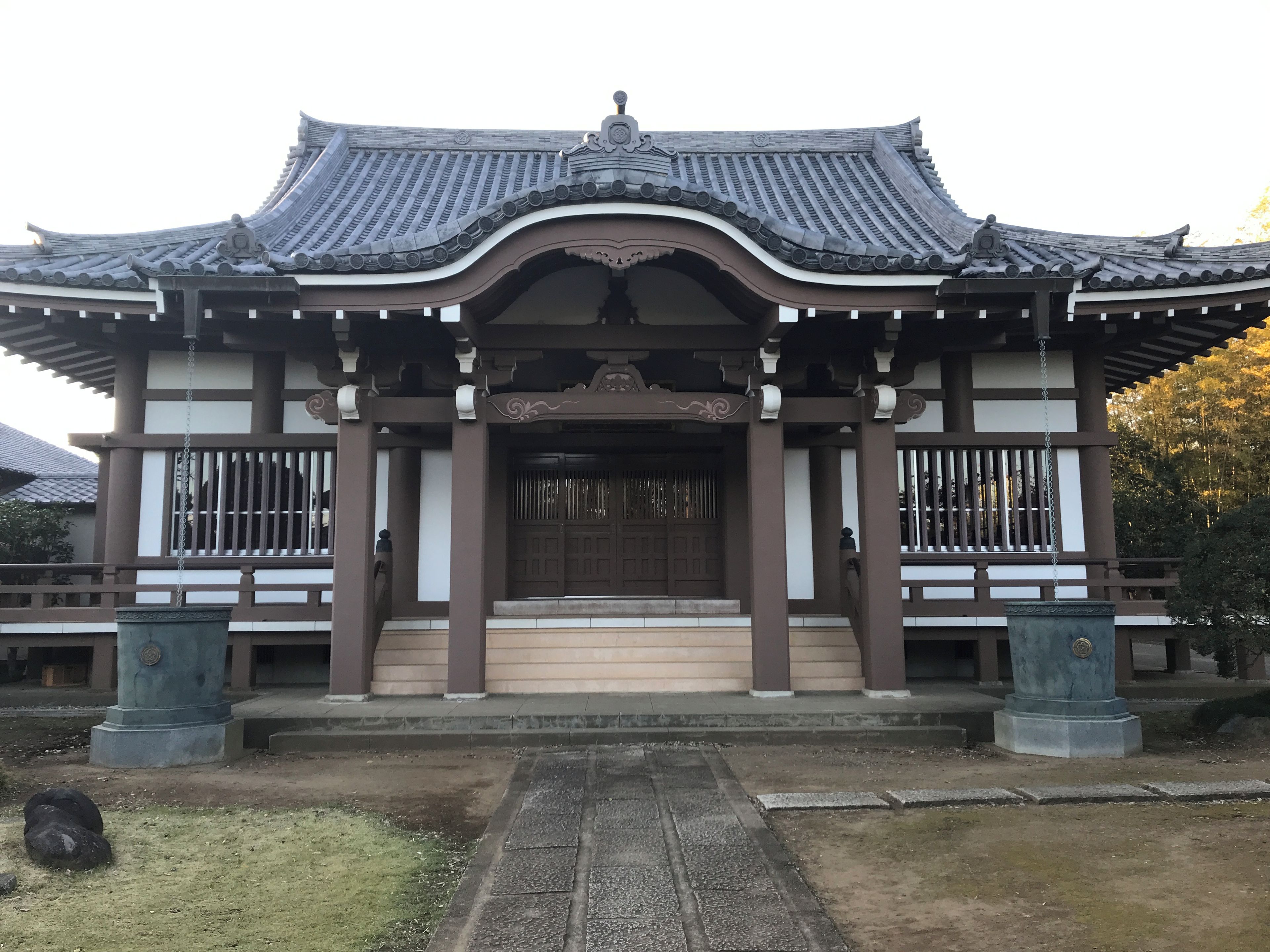 A traditional building with a curved roof, a central entrance, and a symmetrical facade.