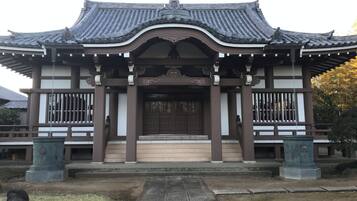 A traditional building with a curved roof, a central entrance, and a symmetrical facade.