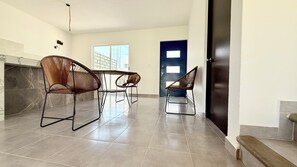 A spacious room with a tiled floor, a fireplace, and three wicker chairs. - Private home with a pool, 5 minutes from Six Flags Oaxtepec (Jardines de Tlayacapan)
