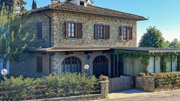A stone building with a pitched roof, arched windows, and a small balcony. - Awesome home in Monte San Savino with WiFi (Monte San Savino)
