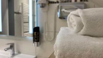 Shower, hair dryer, towels, shampoo