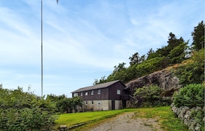 A two-story building with a stone foundation and a dark wooden exterior. - 3 bedroom lovely home in Fister (Fister)