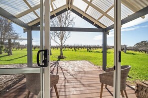A covered outdoor seating area with a view of a vineyard. - Fermoy Lodge—Wine Country Haven & Vineyard Views (Wilyabrup)